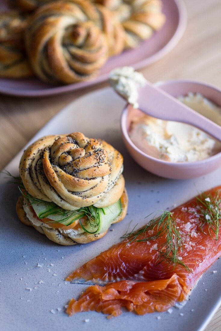 A poppy seed roll with graved lax, cucumber and horseradish cream cheese