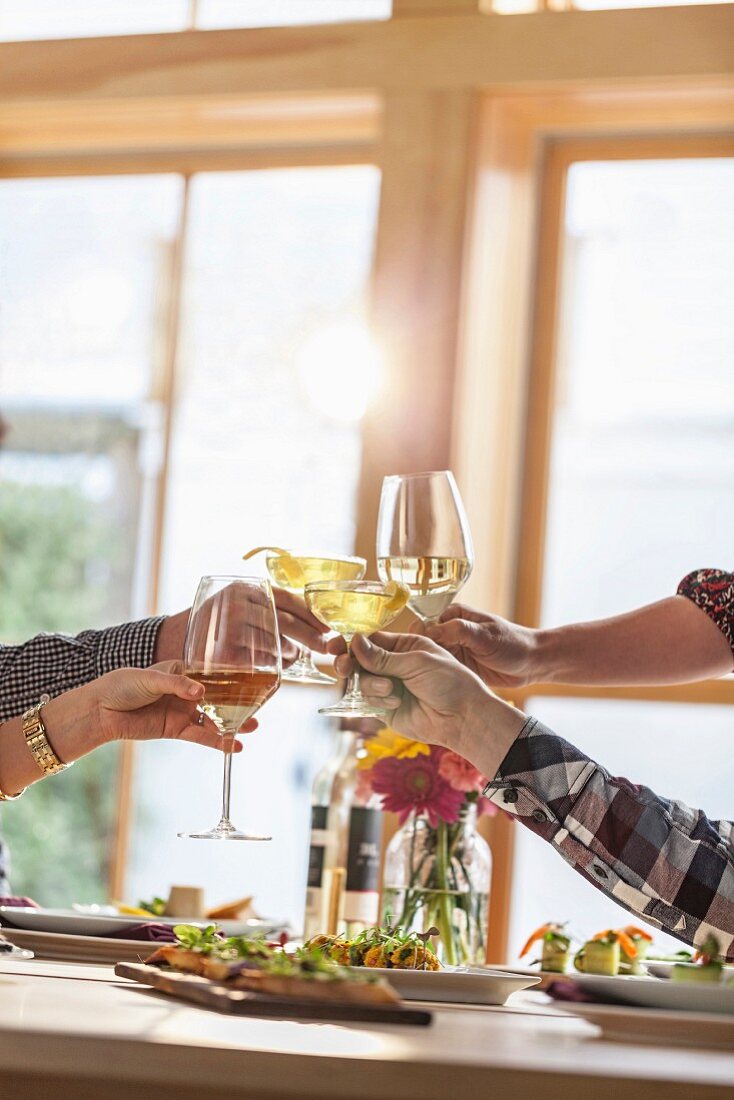 Human hands toasting with wine glasses