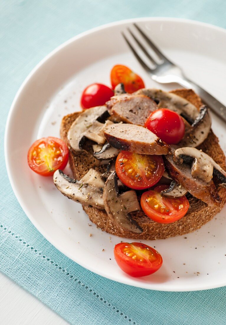 Sausages, mushrooms and cherry tomatoes on toast