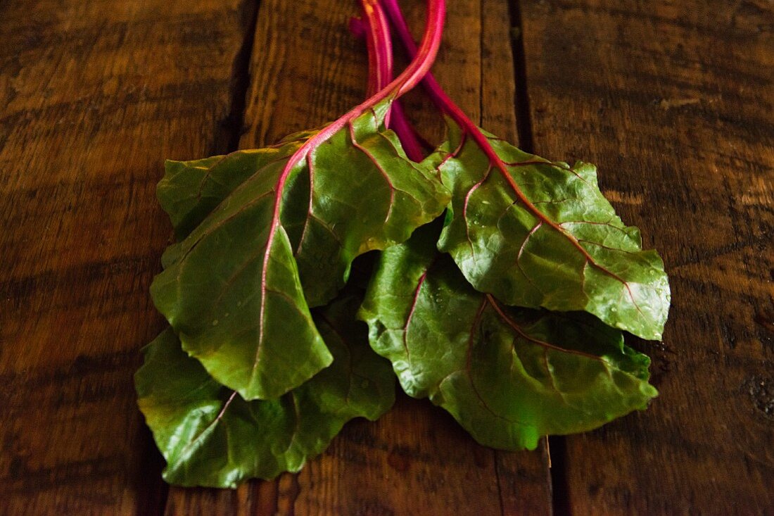 Chard leaves on wooden background
