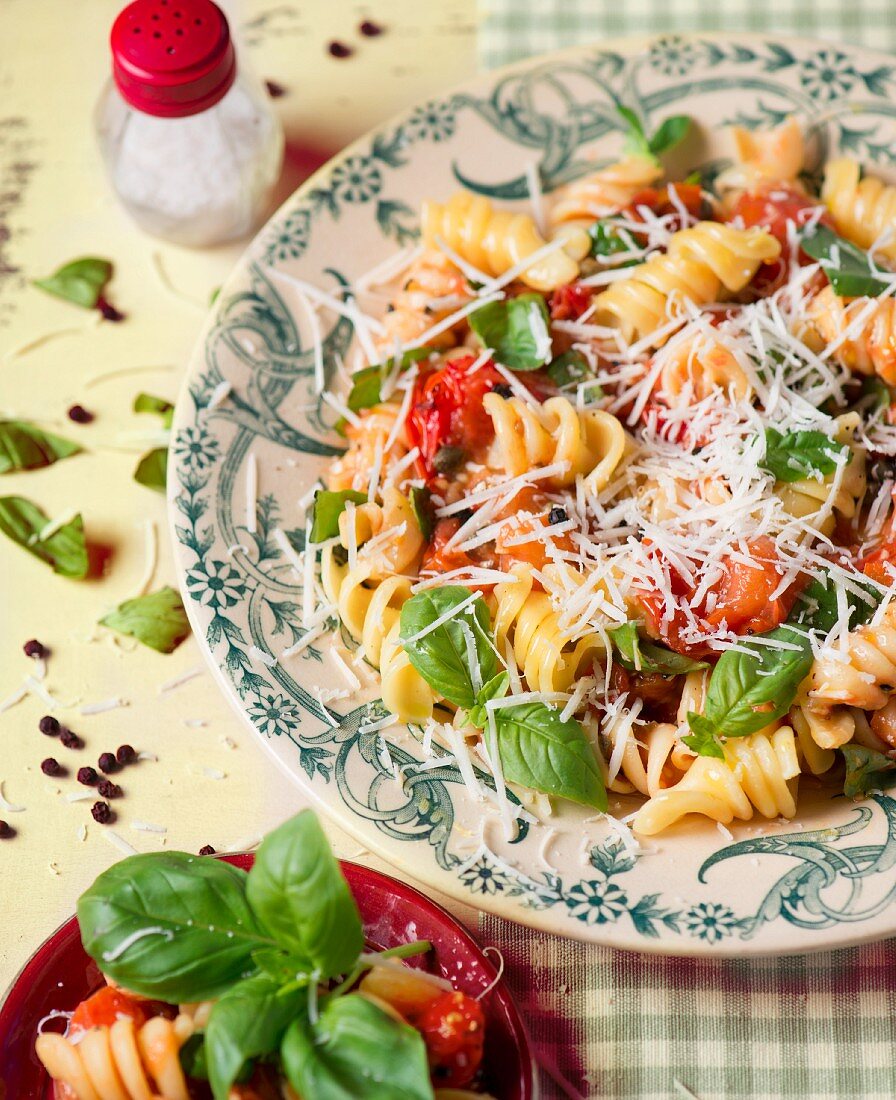 Fusili pasta with tomatoes, basil and grated cheese
