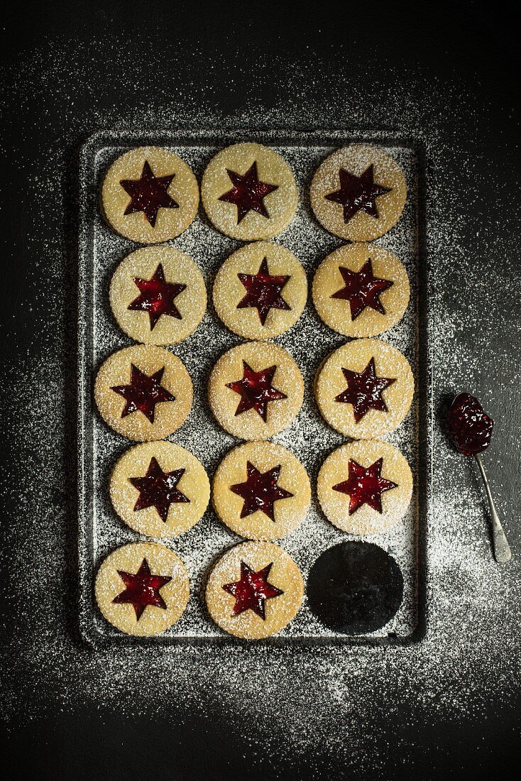 Christmas biscuits with jam stars and icing sugar