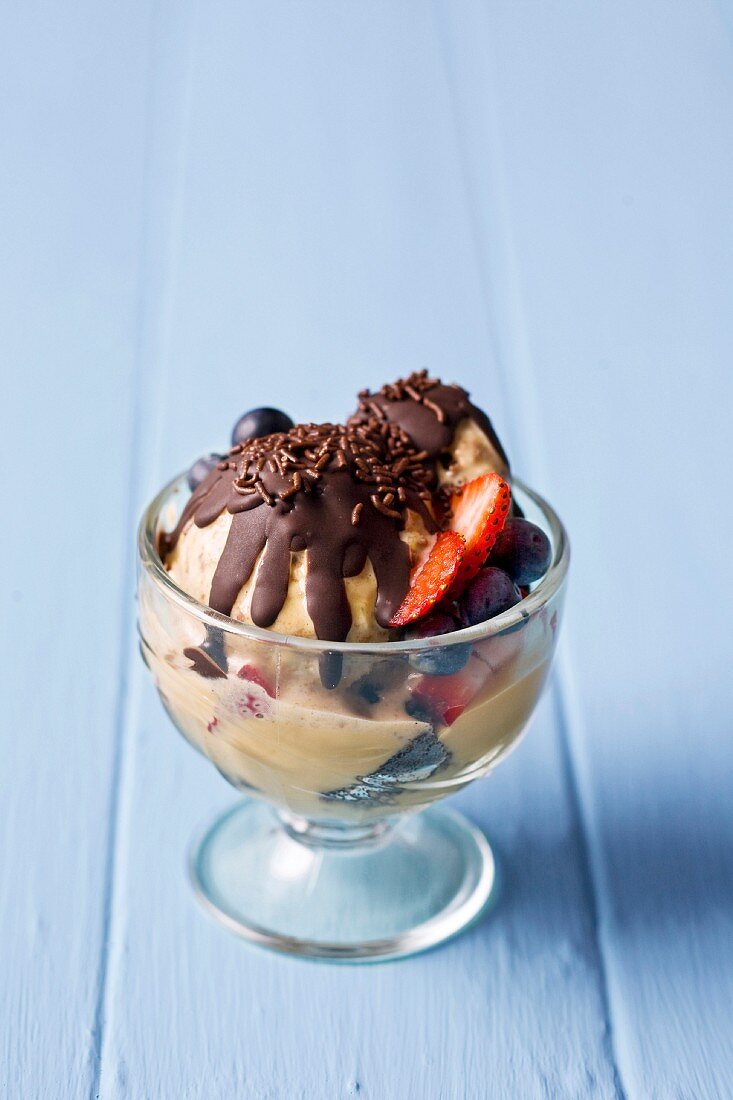 Chocolate and caramel ice cream with berries