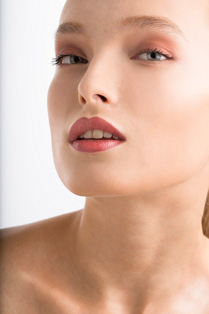 A young woman with rosé tinted make-up