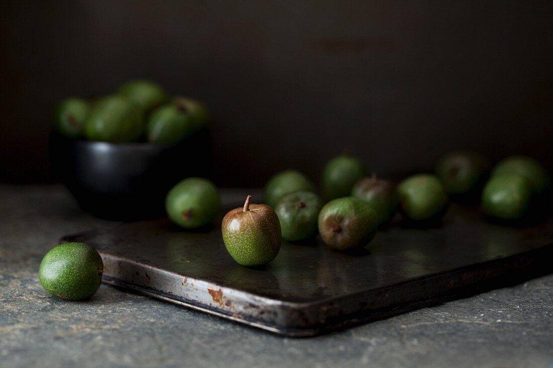 Kiwi berries on a rustic baking tin