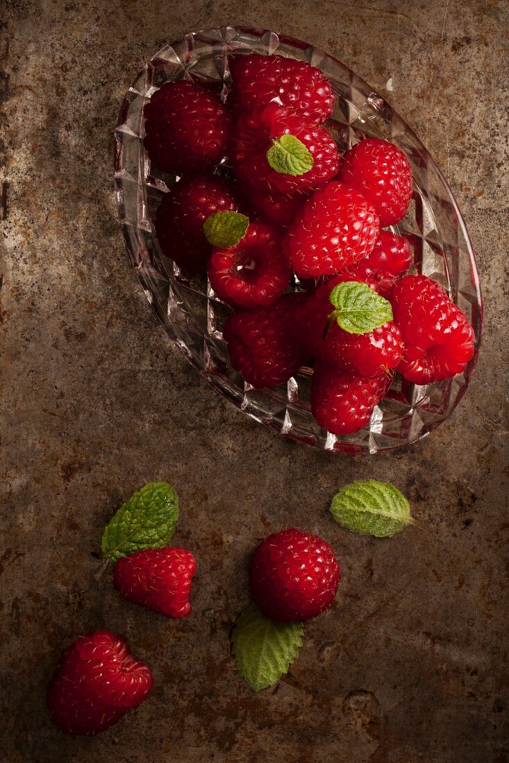 Fresh raspberries and mint on a baking tray
