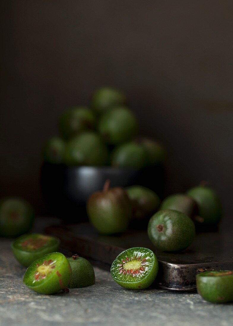Kiwi berries, whole and halved, on a baking tray