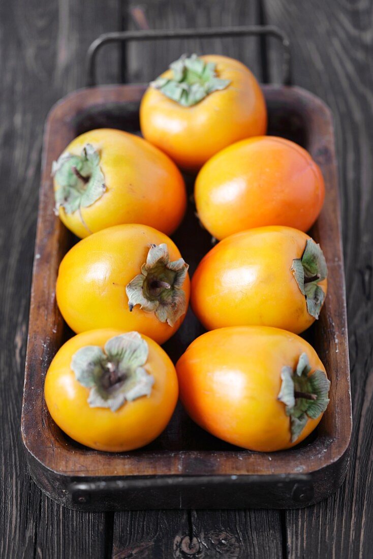 Fresh persimmons on a tray