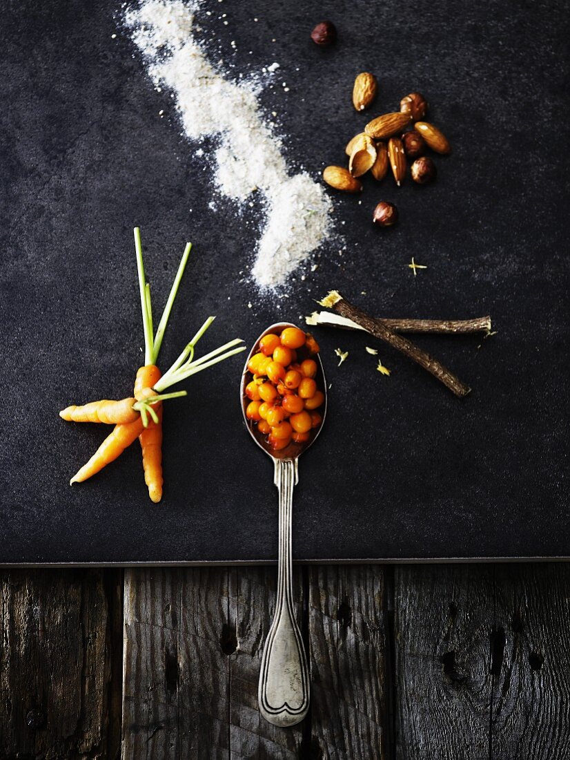 Ingredients for carrot cake on a black surface