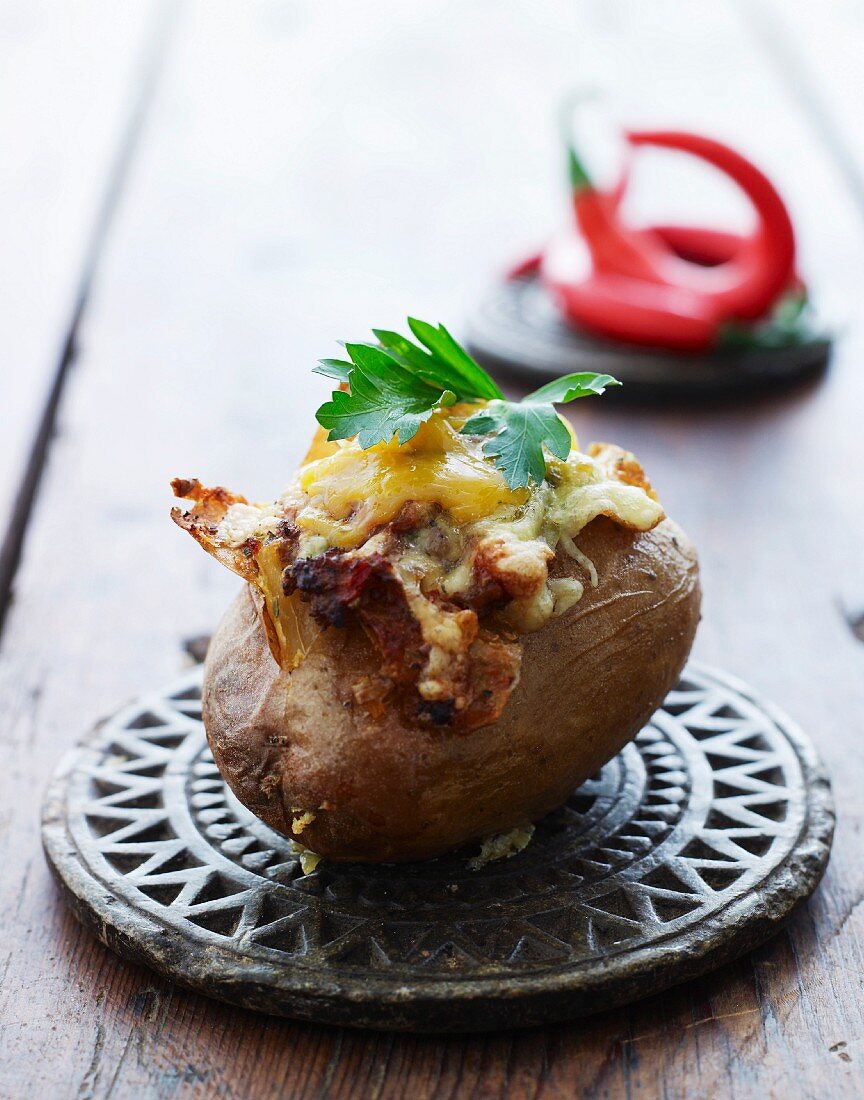A baked potato with bacon and cheese