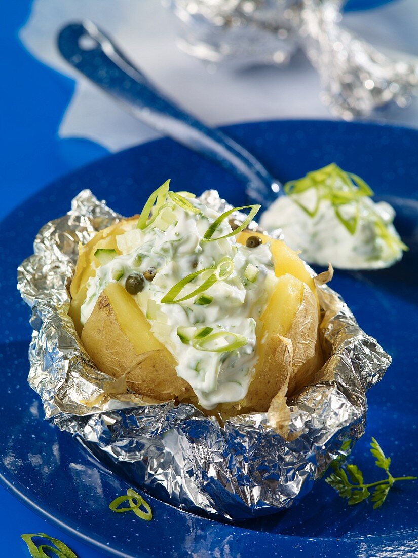 A baked potato with quark and spring onions
