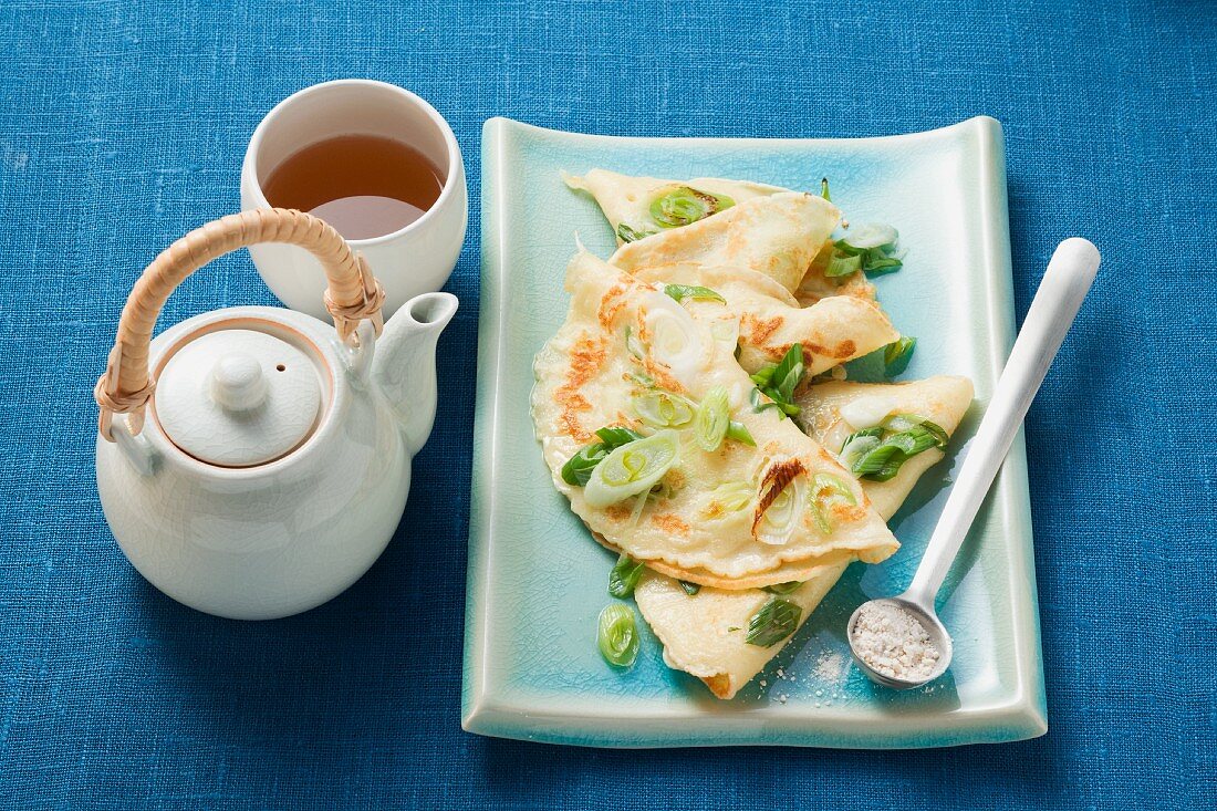 Pancakes with spring onions served with tea