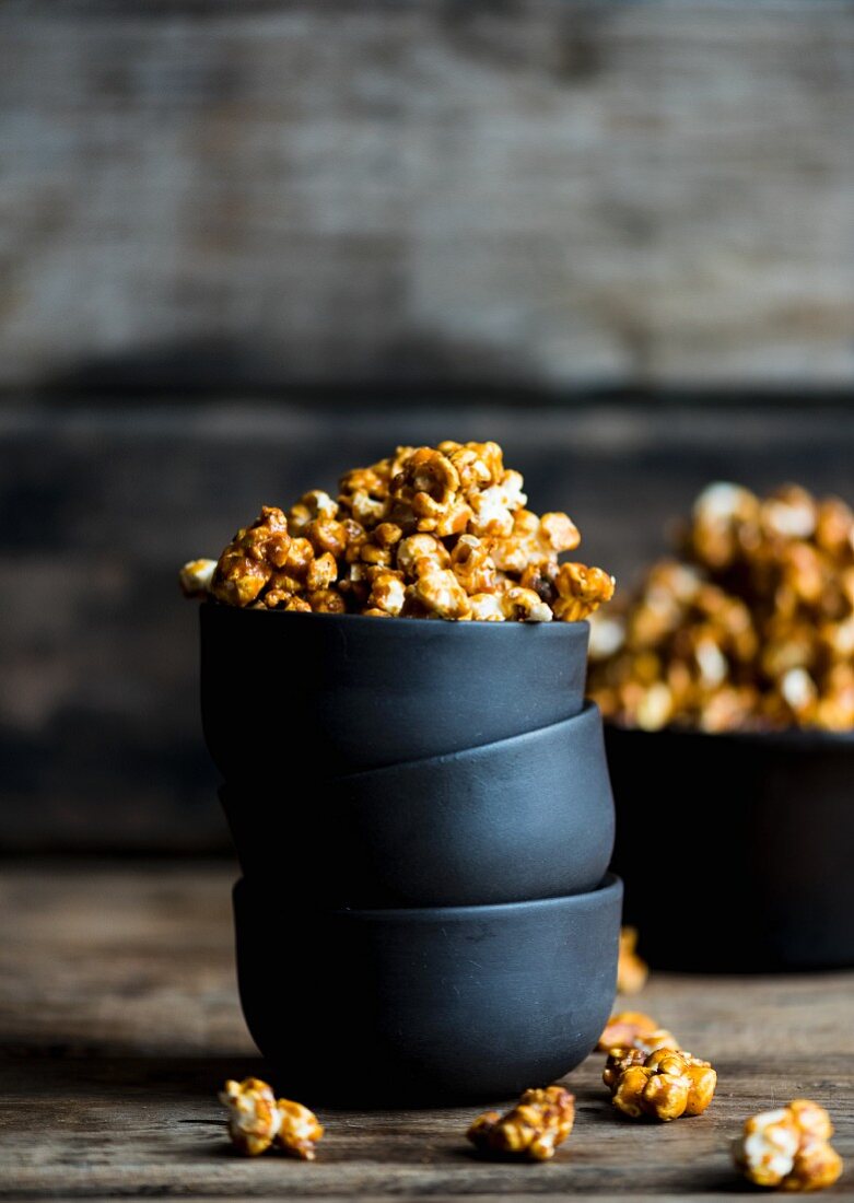 Caramelised popcorn in a stack of bowls