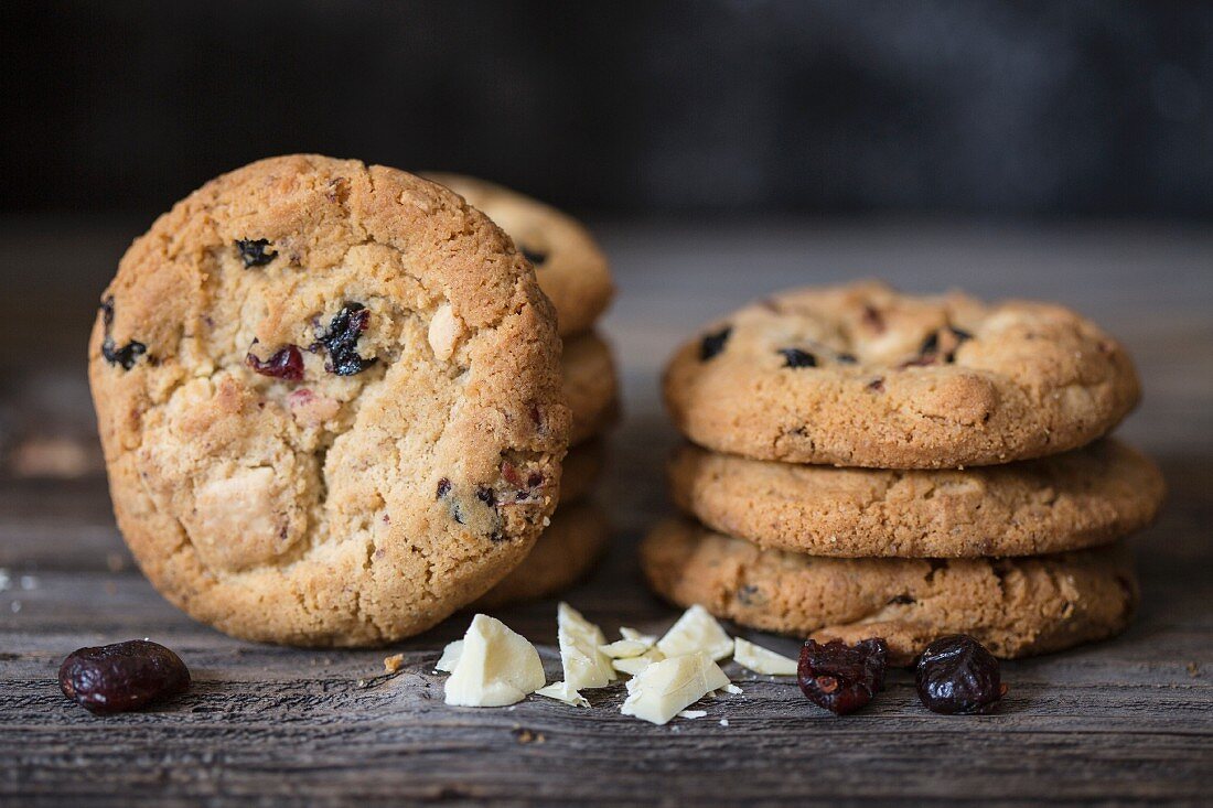 A stack of cookies with white chocolate and dried cranberries