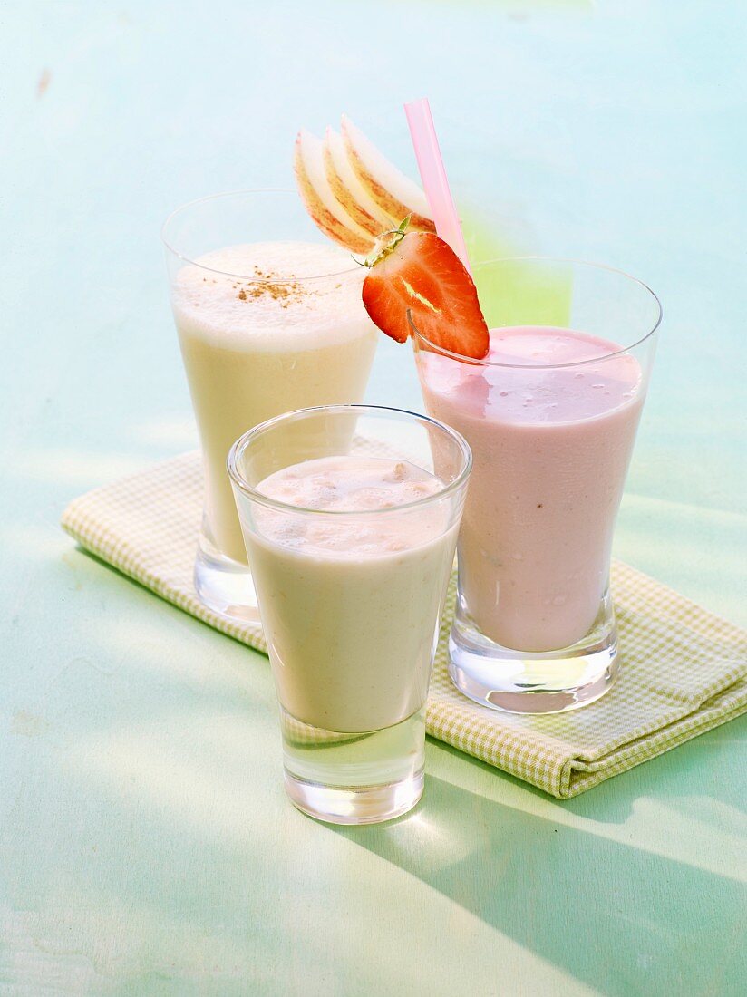 A soya grapefruit drink, a strawberry yoghurt frappe and an apple and vanilla milkshake