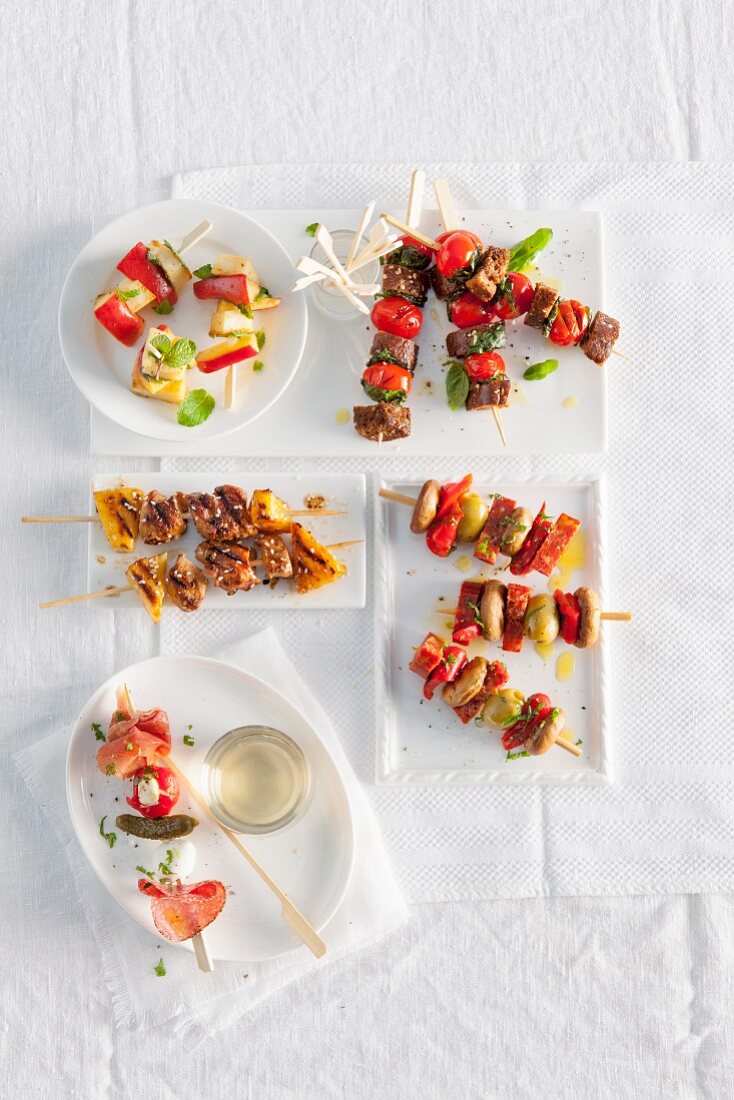 Various skewers on white plates for a Christmas party