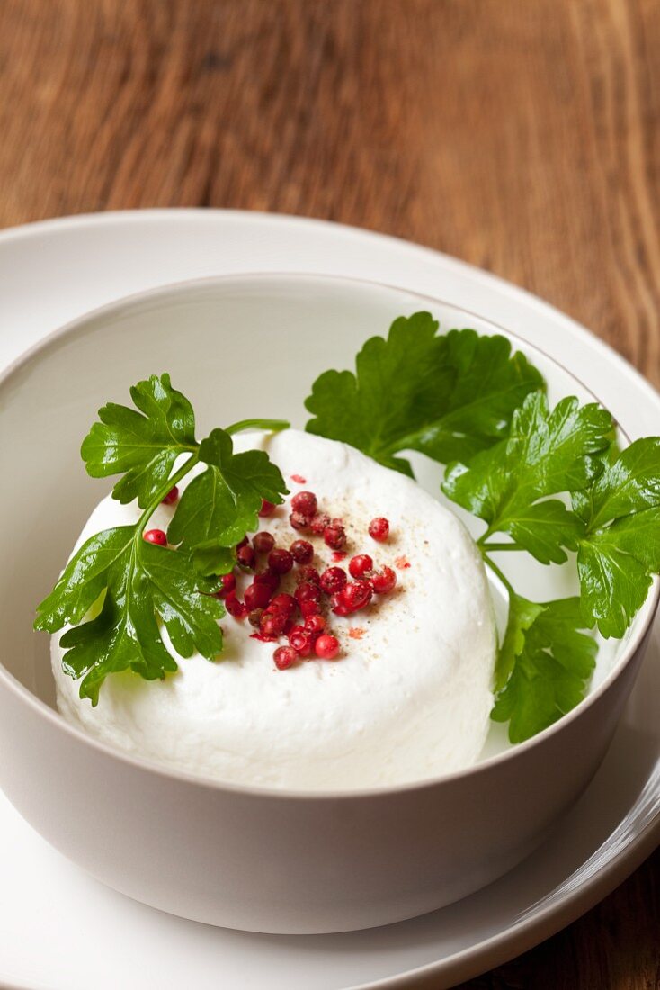 Goat's cream cheese with pink pepper and parsley