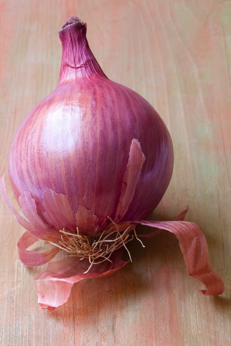 A red onions on a wooden surface