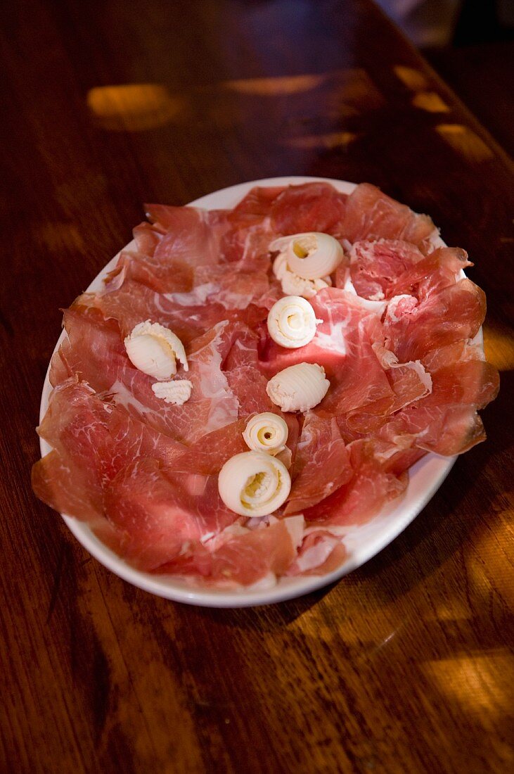 Culatello, sliced, on a plate
