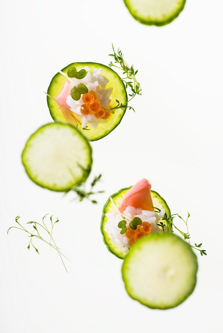Cucumber slices with sushi rice, caviar and ginger