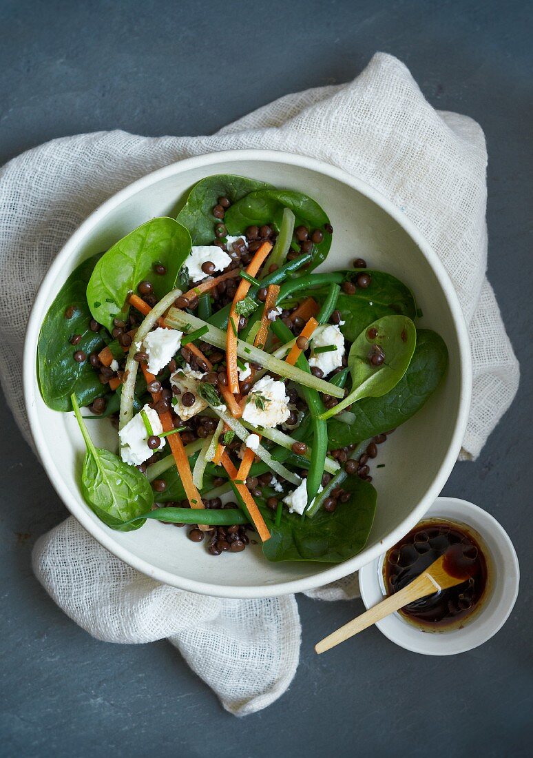 Spinach salad with lentils, beans and feta cheese
