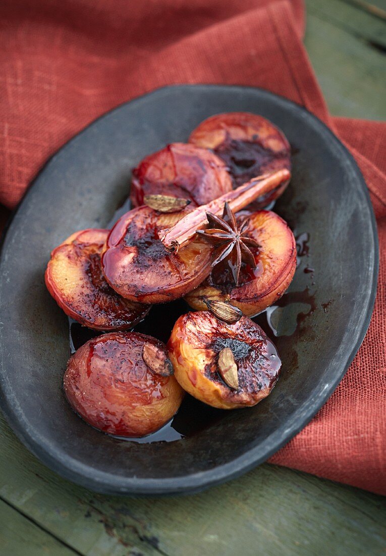 Oven-baked plums in a spiced red wine sauce