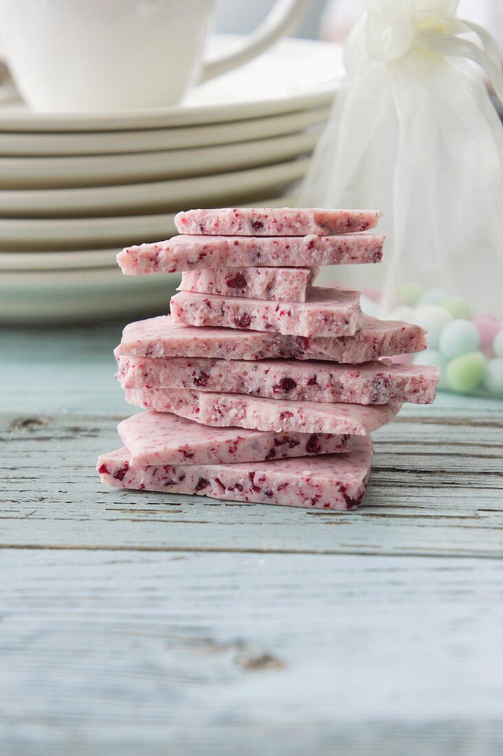 A stack of raspberries chocolate on a rustic wooden surface