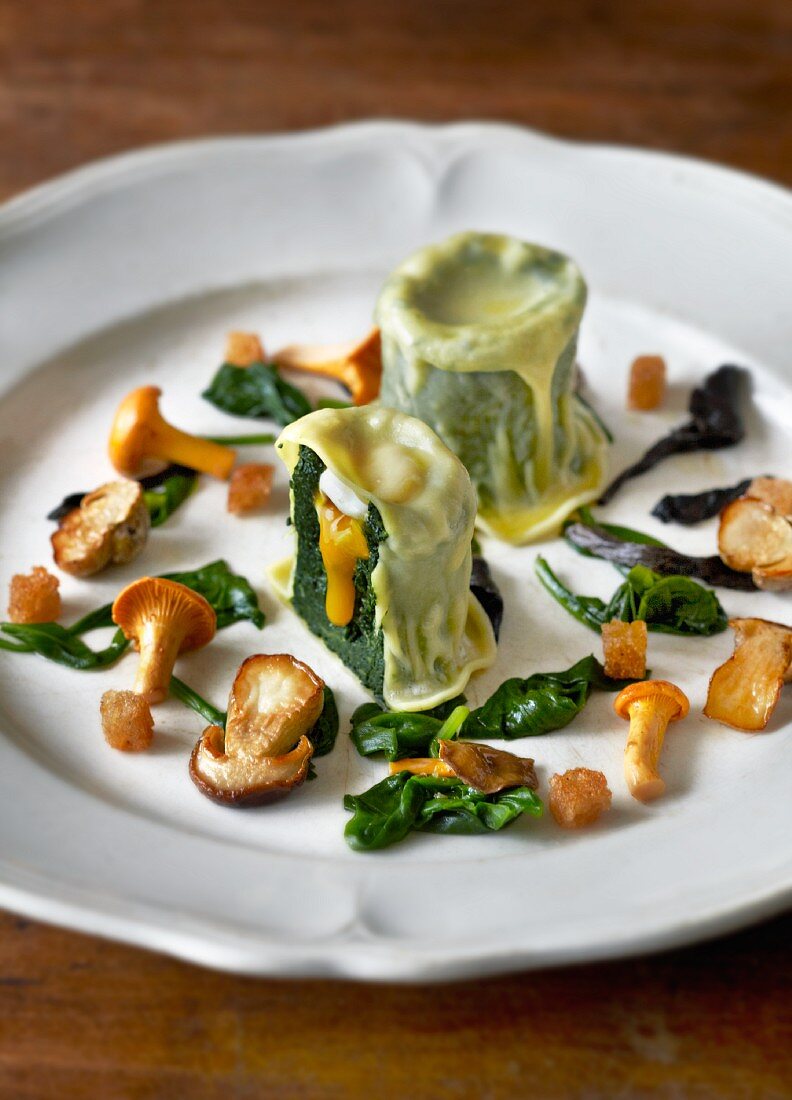 Spinach ravioli with quail and wild mushrooms
