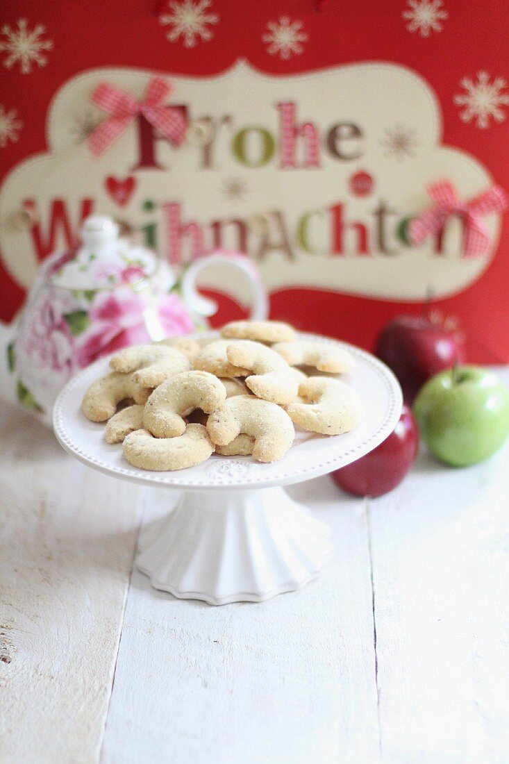 Vanilla crescent biscuits on a white cake stand