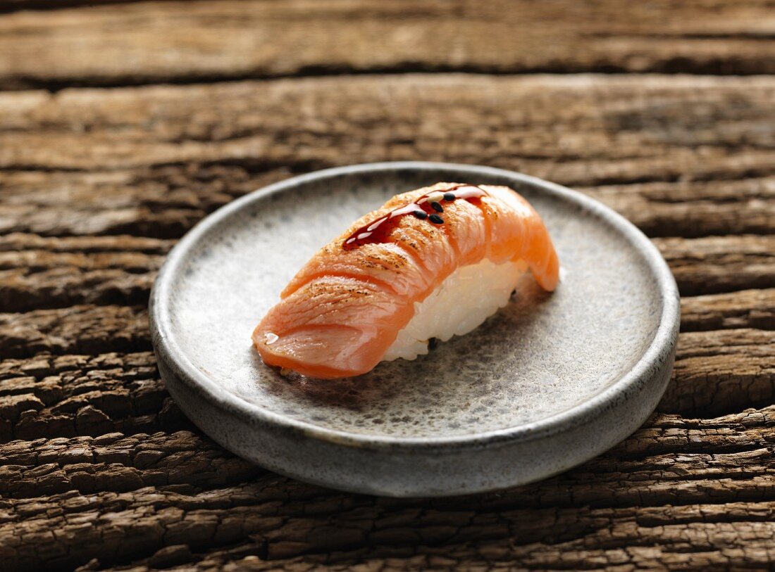Nigiri sushi with fried salmon and teriyaki sauce
