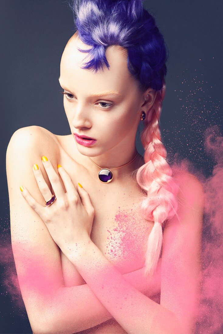 A young woman with a purple and pale pink hair piece and a dusting of pink powder