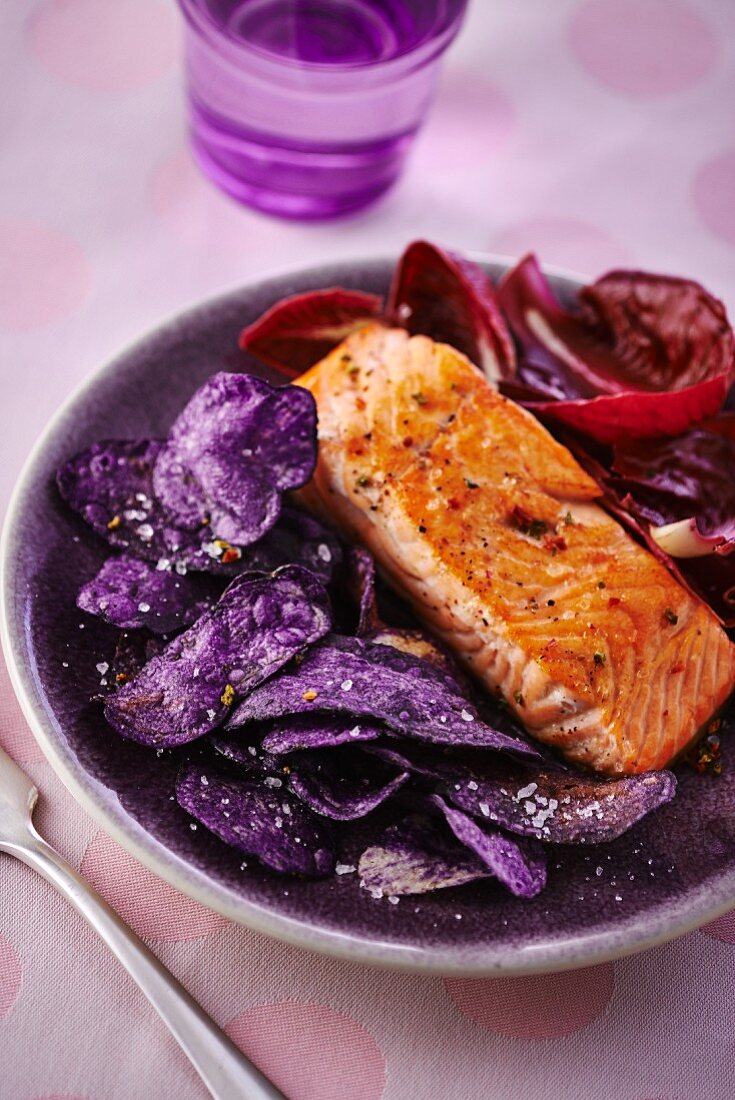 Gebratener Lachs auf violetten Kartoffelchips und Radicchiosalat