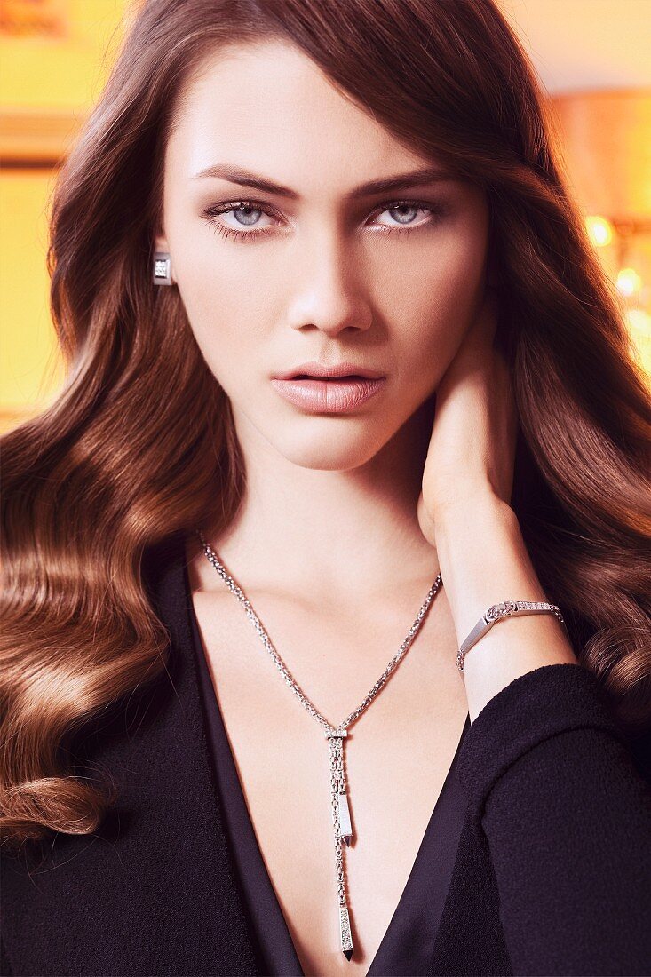 A young brunette woman wearing silver jewellery