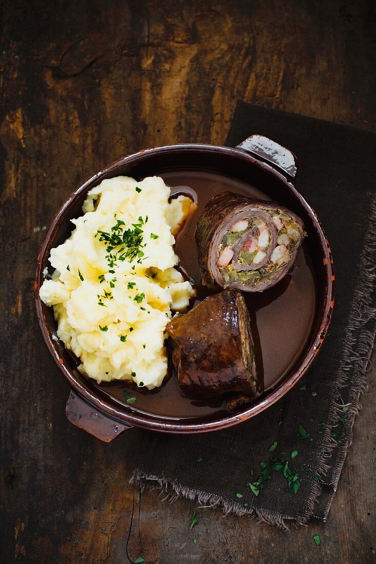 Beef roulade with bacon and gherkins served with mashed potatoes is