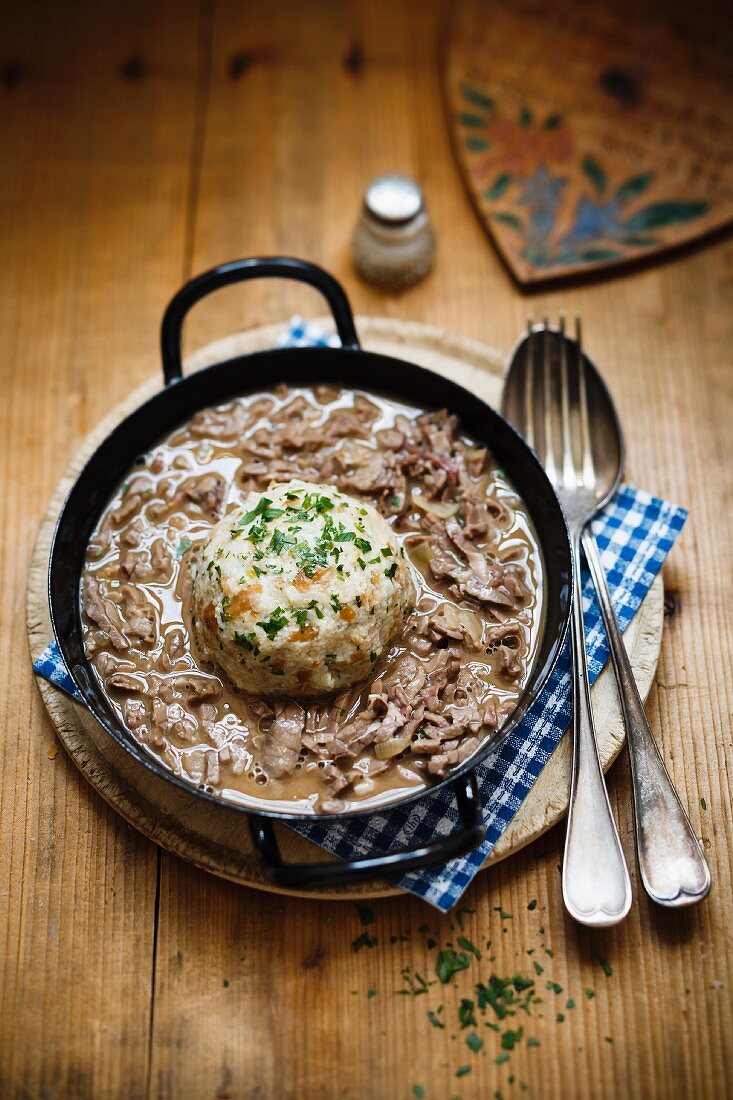 Saure Lunge (Bavarian ragout made with veal lungs) served with a bread dumpling