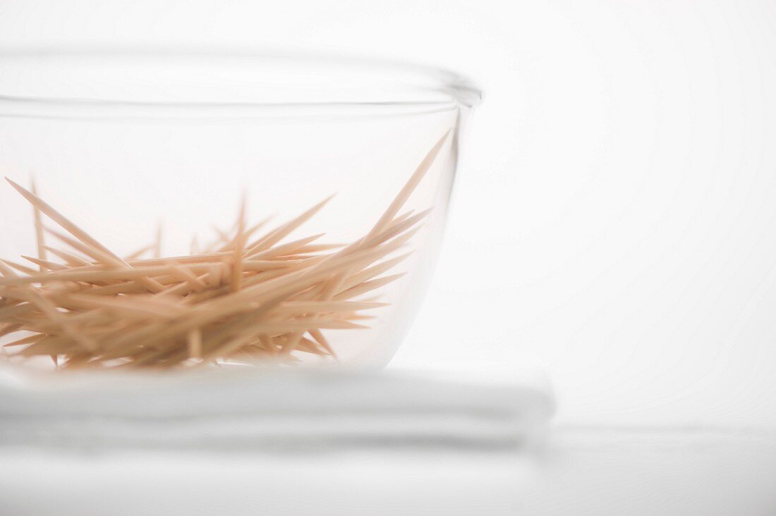 A glass bowl of toothpicks seen from below