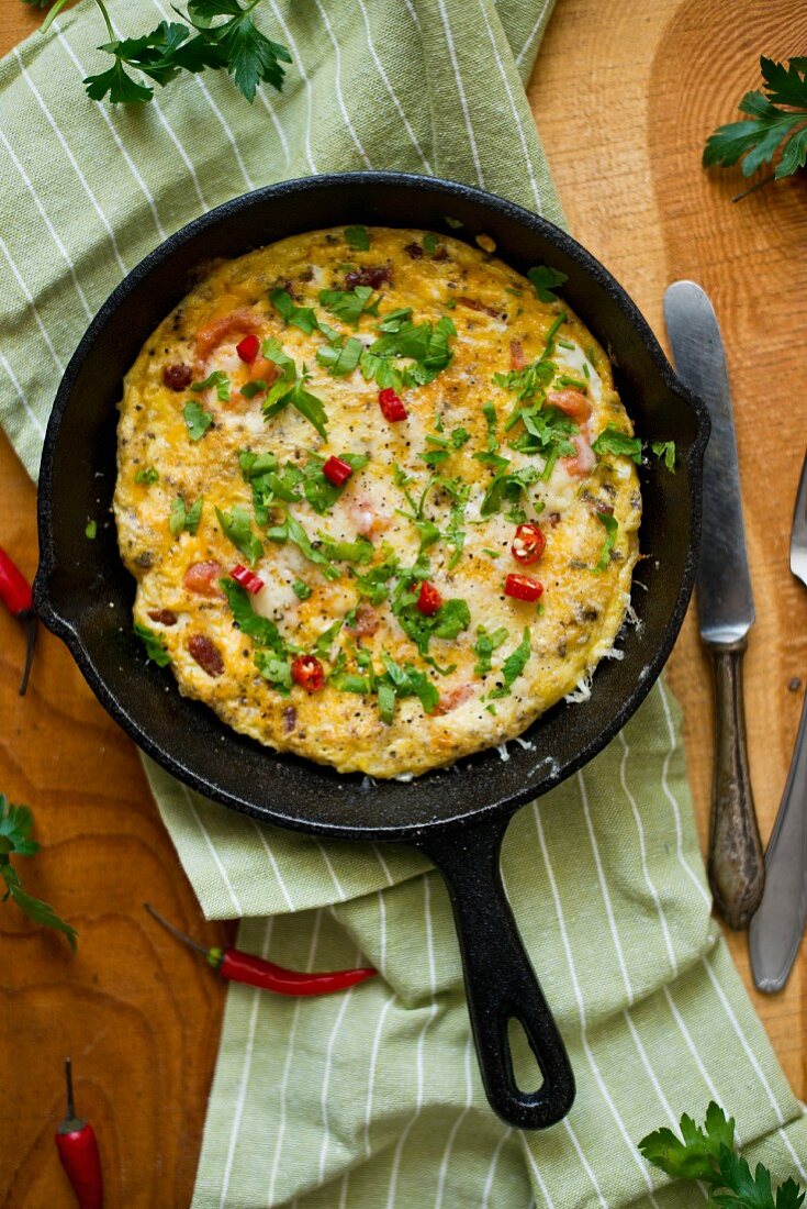 An omelette with parsley and chilli rings