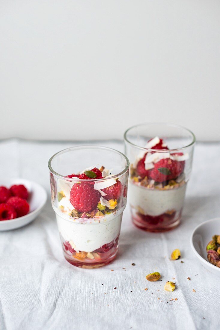 Coconut yogurt with fresh raspberries and pistachio nuts