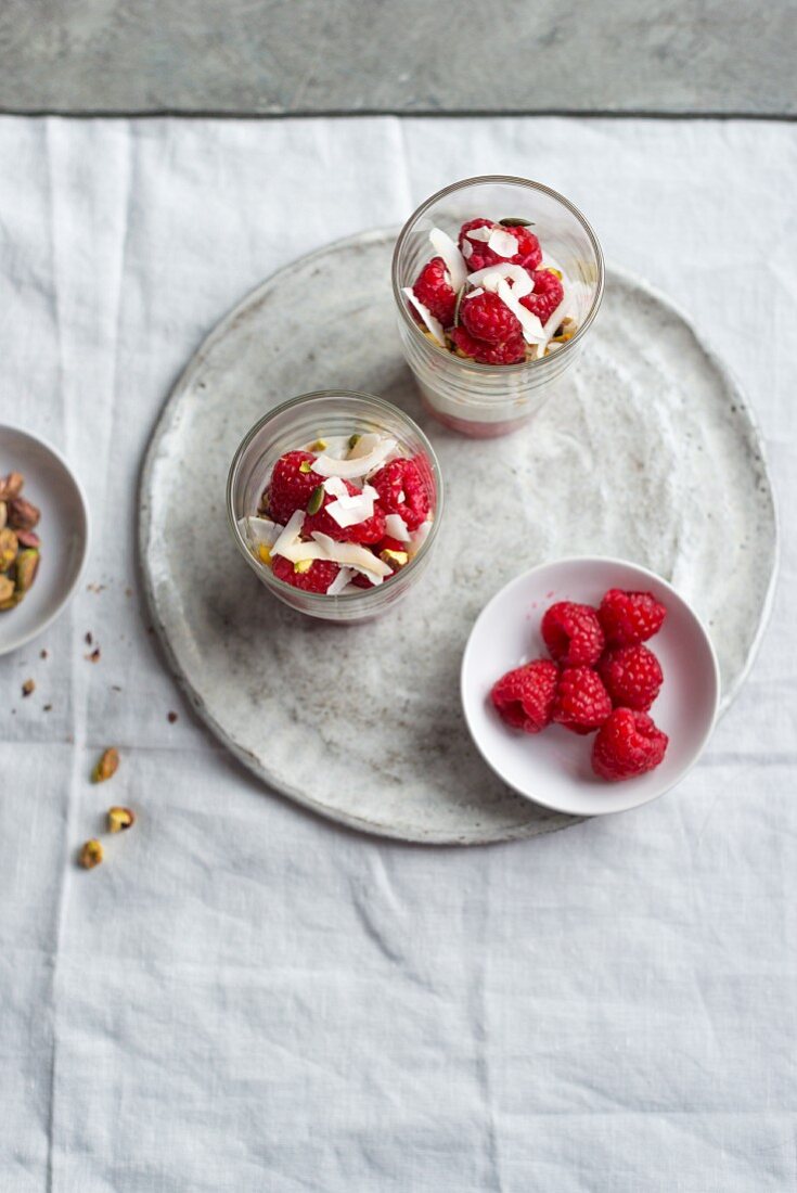 Yogurt with fresh raspberries, pistachios and coconut flakes