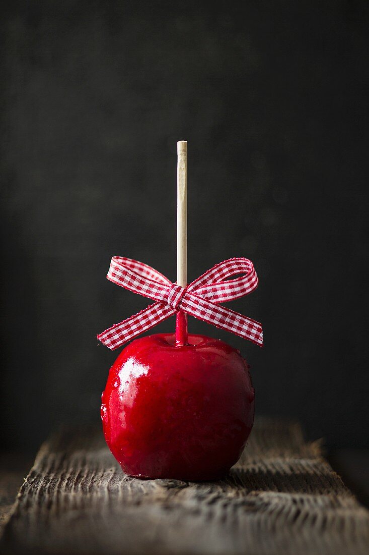 A toffee apple with a checked bow