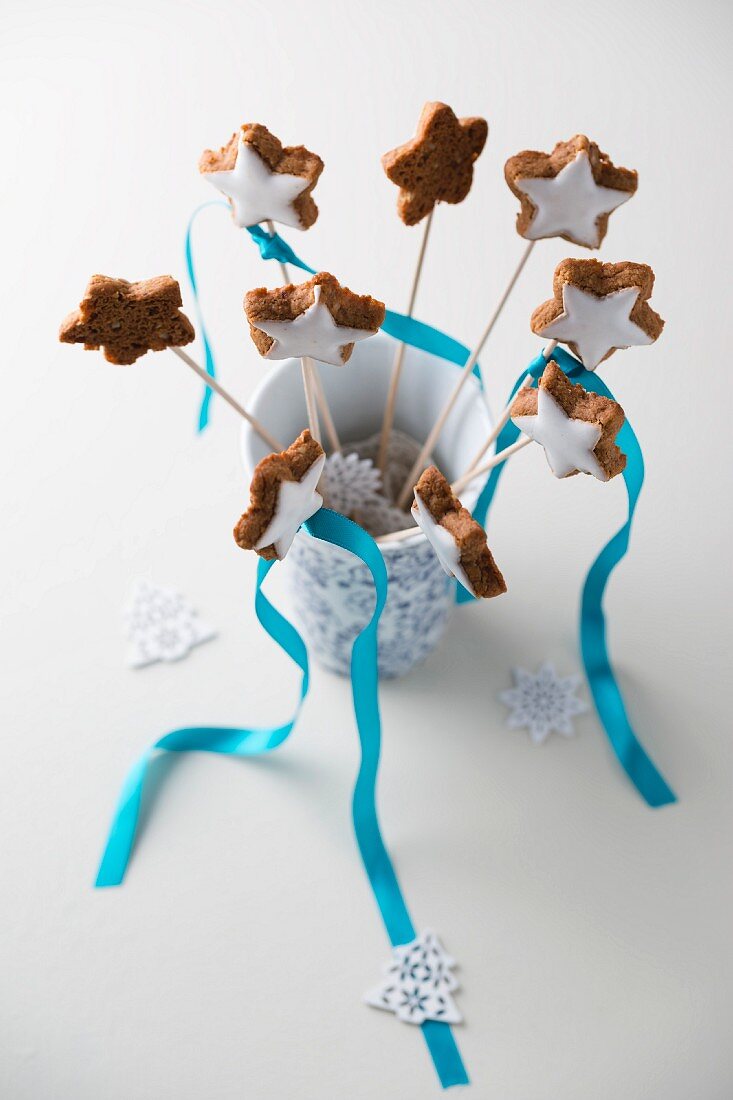 Cinnamon stars on sticks in a vase with sugar