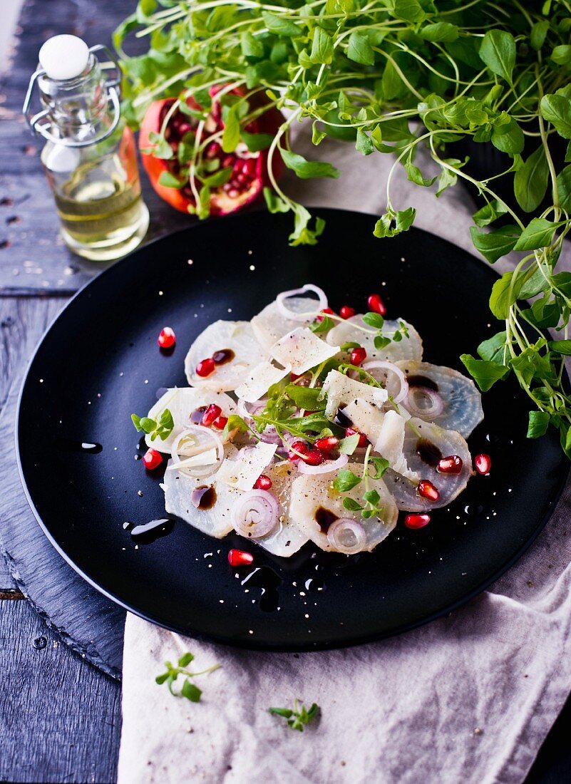 White beetroot carpaccio with onions and pomegranate seeds