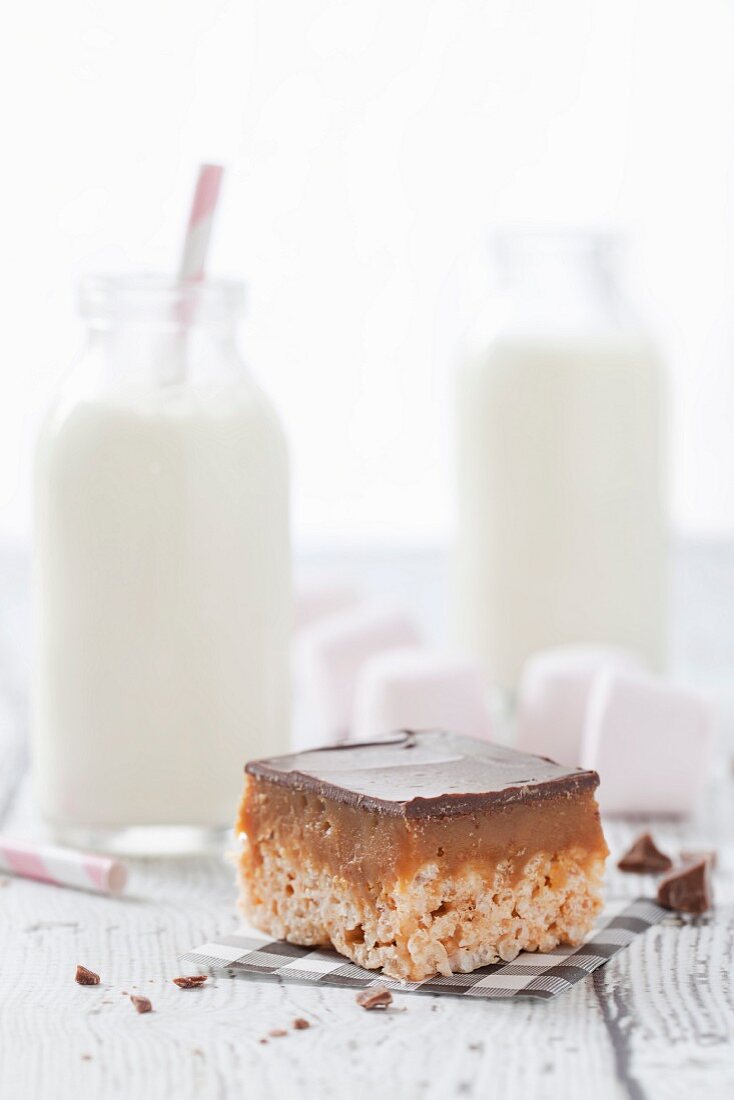 Millionaire's chocolate caramel crispie cake served with milk and marshmallows