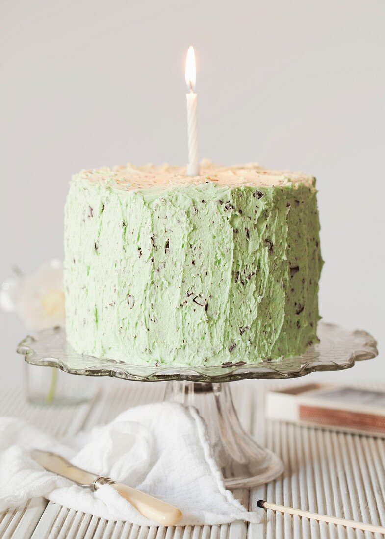 Mint chocolate cake with chocolate chips and a candle