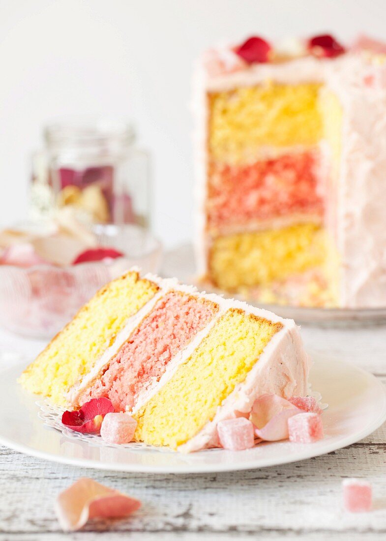 A slice of Turkish Delight layer cake with rose petals