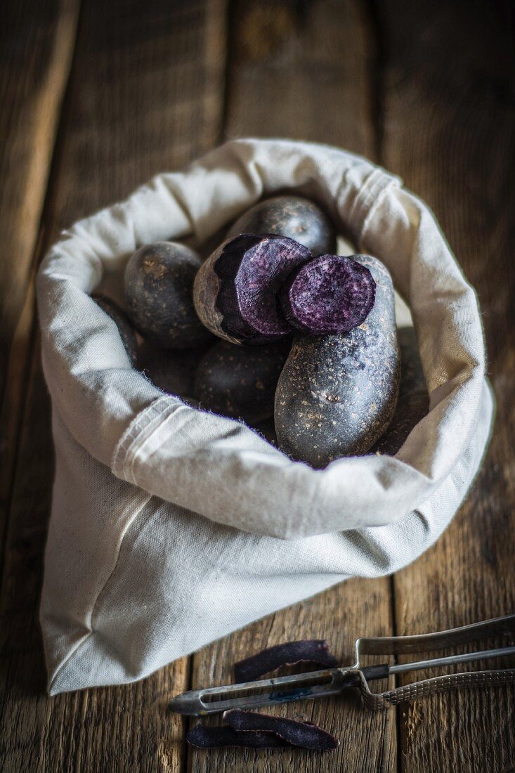 Purple potatoes in a fabric bag