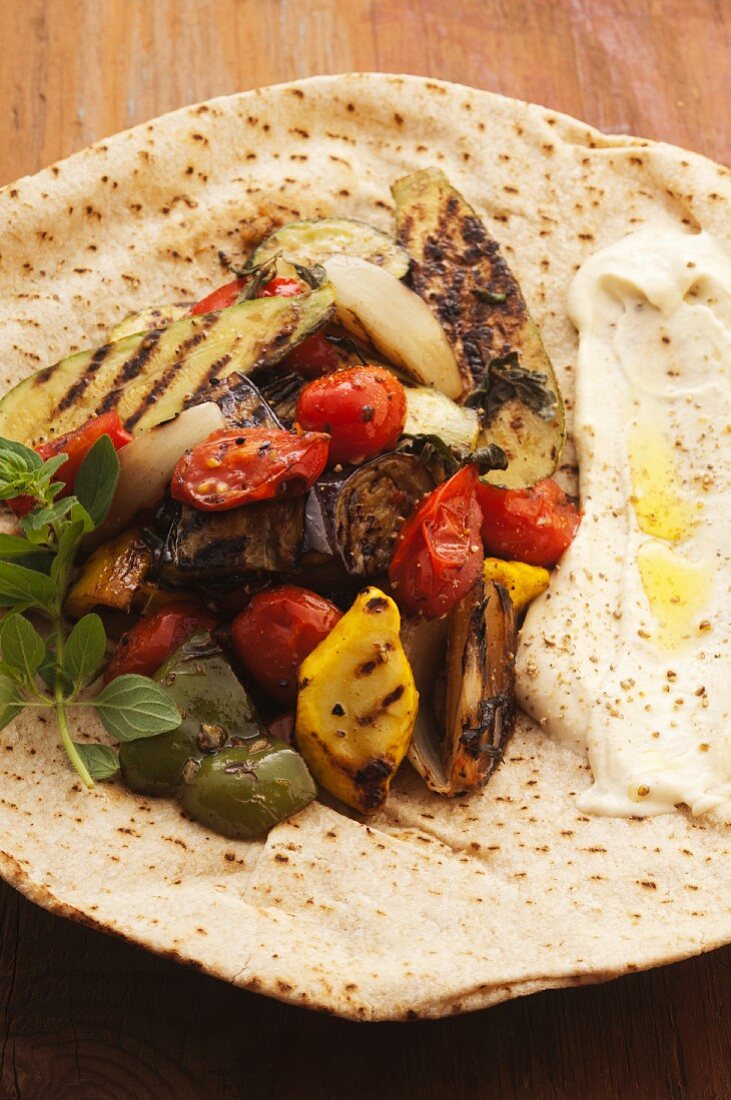 Grilled vegetables and hummus on pita bread