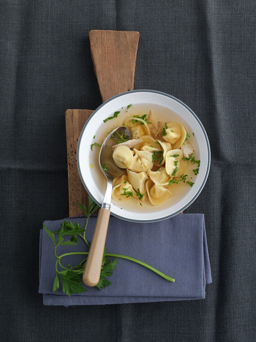 Clear broth with cappelletti and parsley