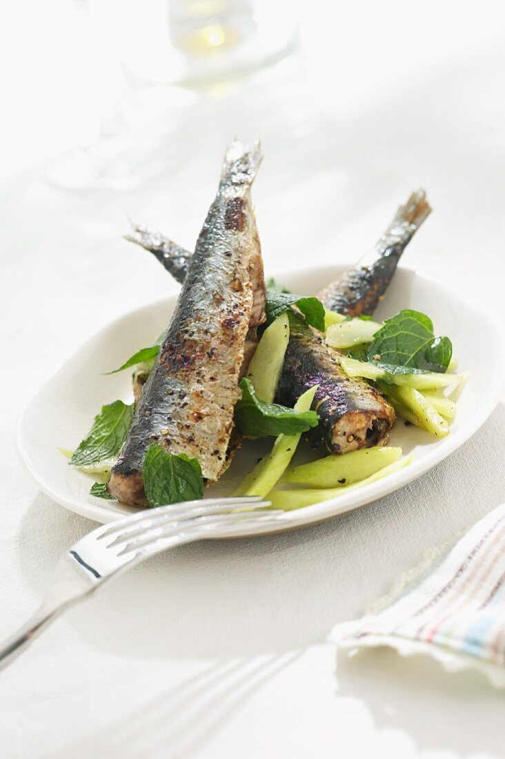Fried herring on a vegetable salad