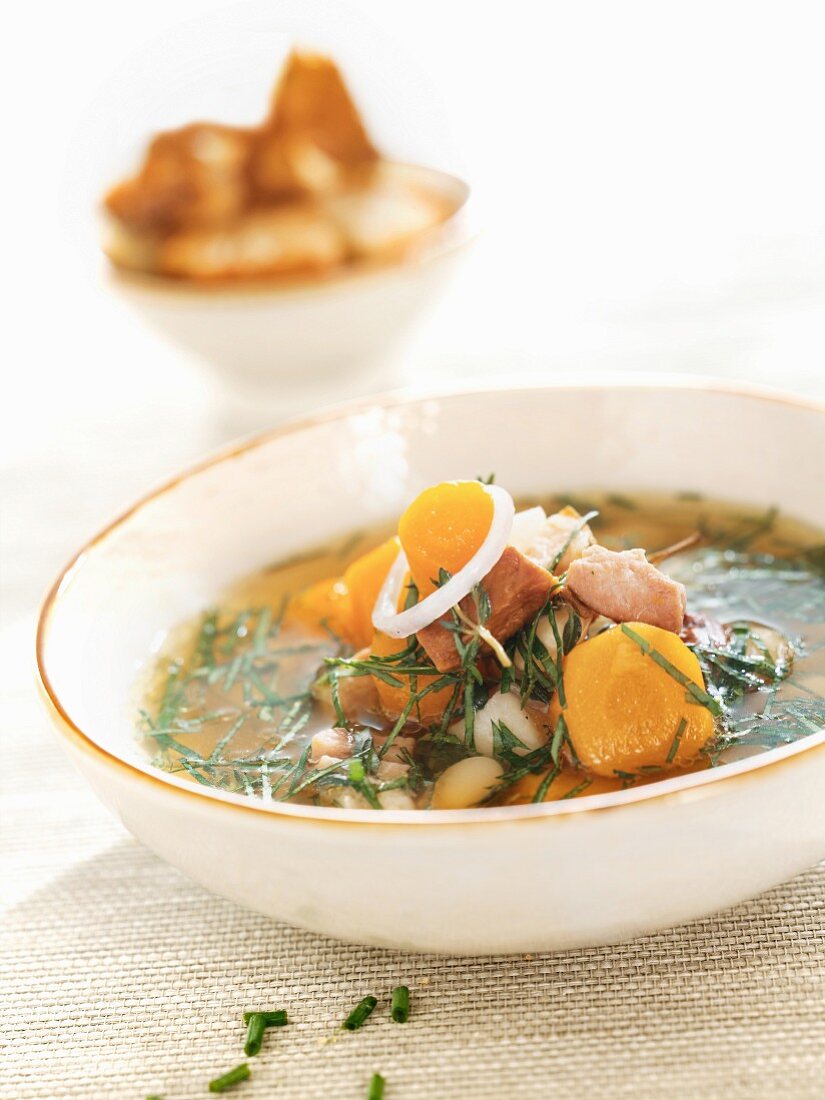 Fish soup with carrots, onions and herbs